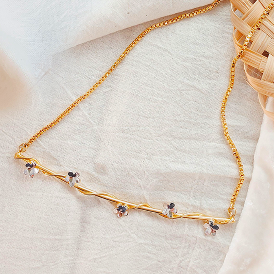Baby’s Breath necklace with golden vine and dual-tone floral accents, crafted in brass with 18K rhodium gold and silver plating