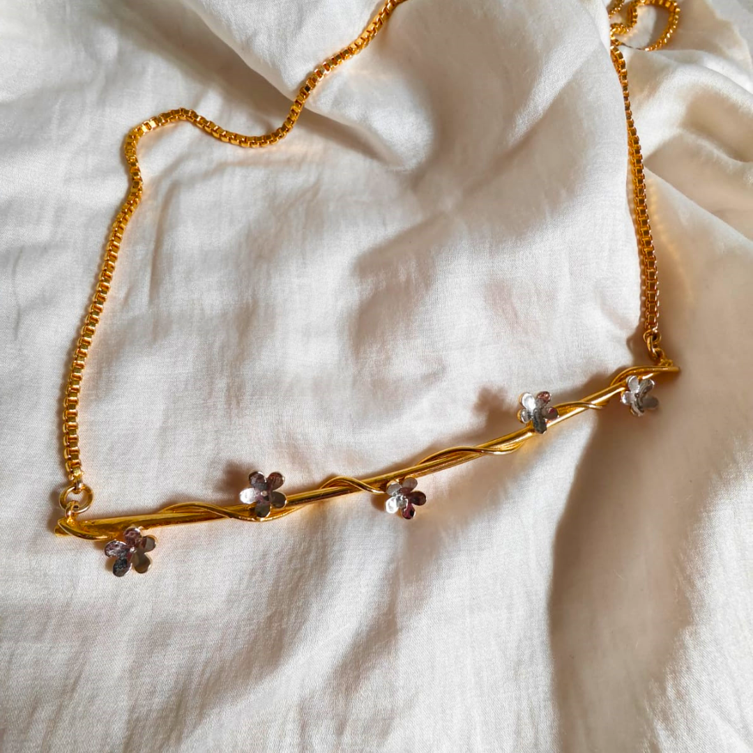 Baby’s Breath necklace with golden vine and dual-tone floral accents, crafted in brass with 18K rhodium gold and silver plating