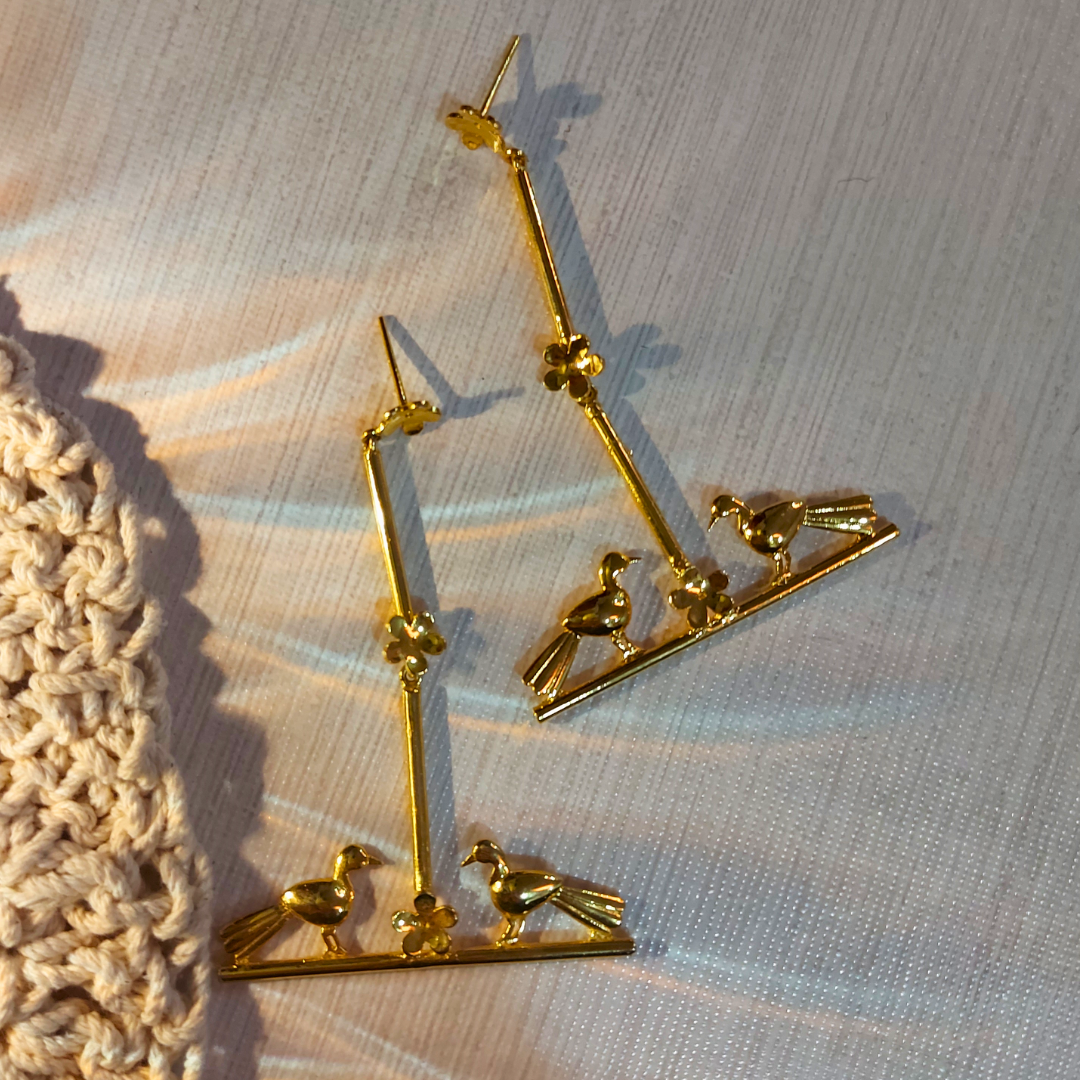 Nature-inspired Love Birds earrings with golden birds and flower accents, made of brass and rhodium gold