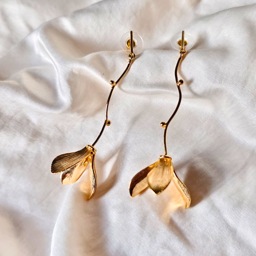 Hanging flower earrings with matte-gold petals and flowing vine stems, made from brass and 18K rhodium gold plating