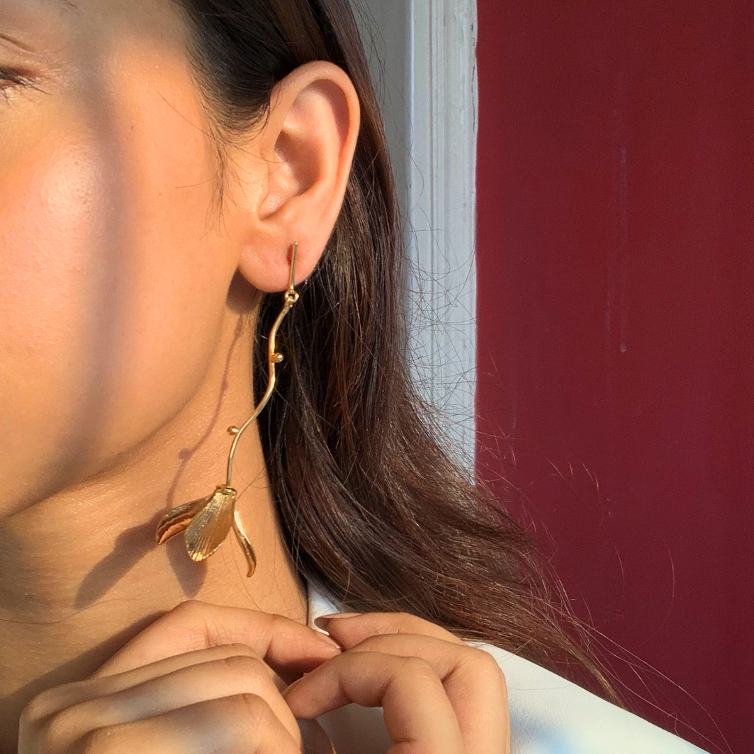 Hanging flower earrings with matte-gold petals and flowing vine stems, made from brass and 18K rhodium gold plating