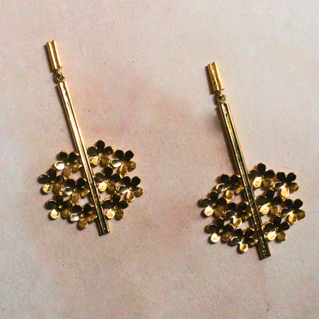 Handcrafted brass earrings finished with radiant 18K rhodium gold plating, featuring vertical stem-like bars and clustered golden petal blooms
