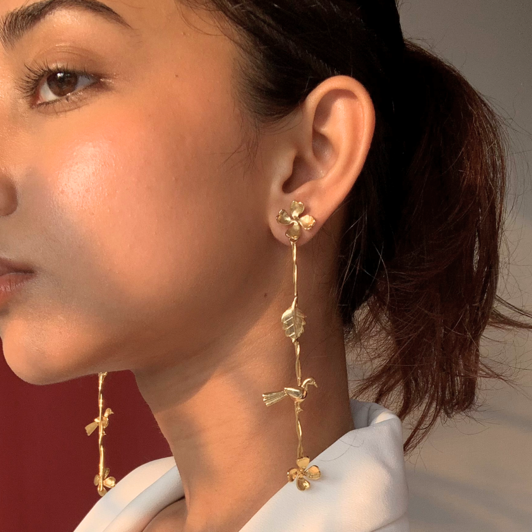 Gold Plated Long Dangler Earrings Featuring Delicate Twisted Stems, Floral Motifs, Textured Leaves, and Small Perched Birds