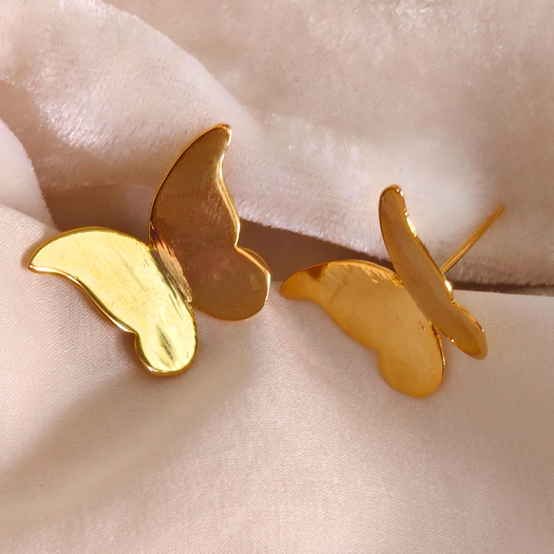 A pair of Gold Plated Butterfly Earrings featuring sleek, minimalist butterfly-shaped designs crafted from brass with a shiny 18k rhodium gold finish.