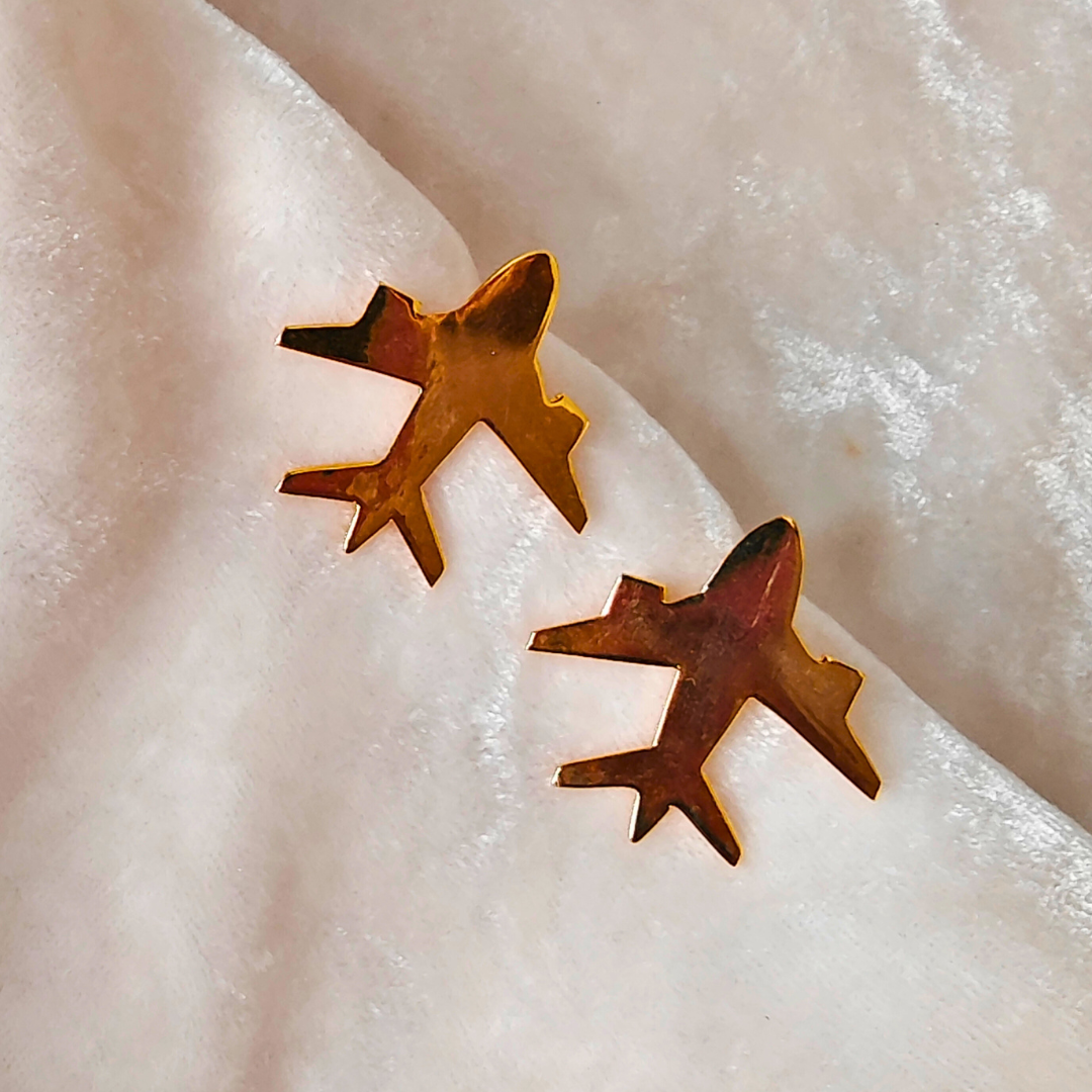 A pair of Gold Plated Aeroplane Earrings featuring minimalist airplane silhouettes crafted from brass and finished with a shiny 18k rhodium gold plating.