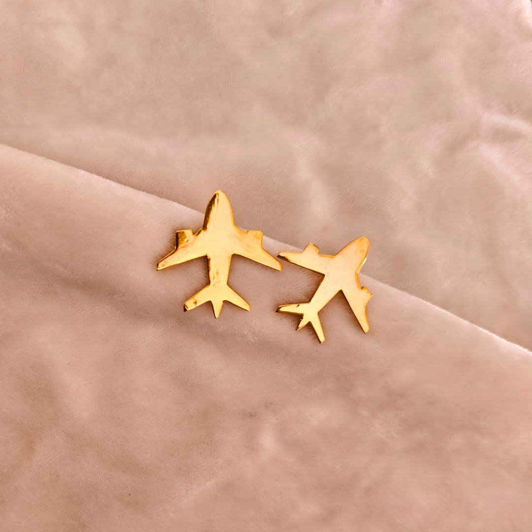 A pair of Gold Plated Aeroplane Earrings featuring minimalist airplane silhouettes crafted from brass and finished with a shiny 18k rhodium gold plating.