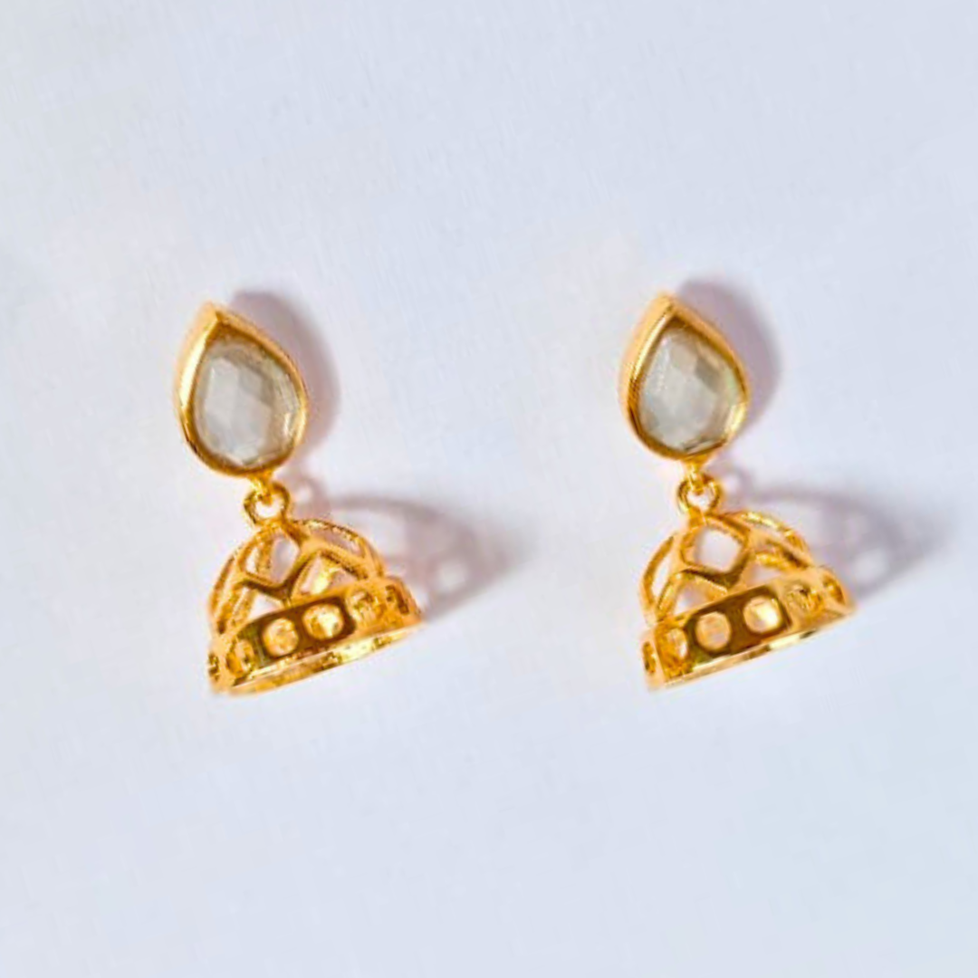 A pair of gold-plated jhumka earrings with pear-shaped faux kundan studs and intricately designed dome-shaped danglers, handcrafted in brass