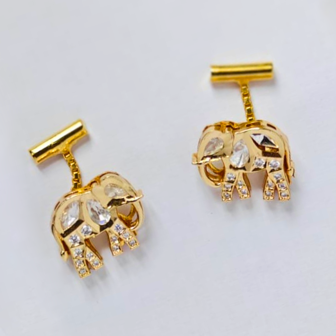 A pair of gold drop earrings shaped like elephants, embellished with sparkling Kundan stones on their bodies and legs, suspended from short vertical bars