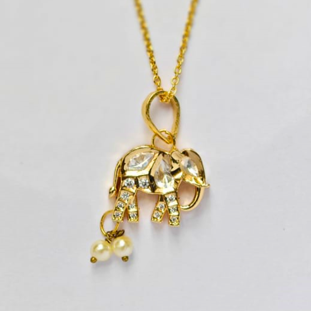 Gold elephant-shaped pendant embellished with Kundan stones and two hanging pearl drops