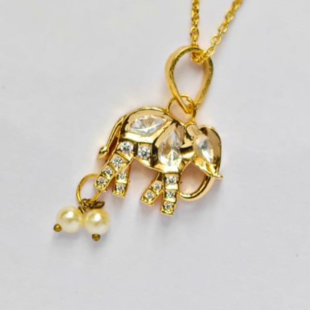 Gold elephant-shaped pendant embellished with Kundan stones and two hanging pearl drops