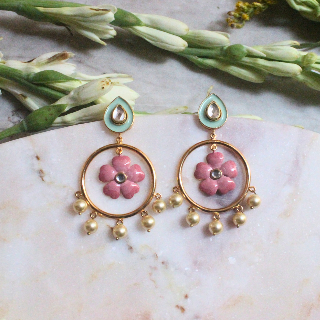 Pair of Gulbahar Enamel Meena Earrings featuring hand-painted pink enamel flowers inside golden hoops, adorned with faux pearl drops and pastel teardrop studs with kundan-style accents