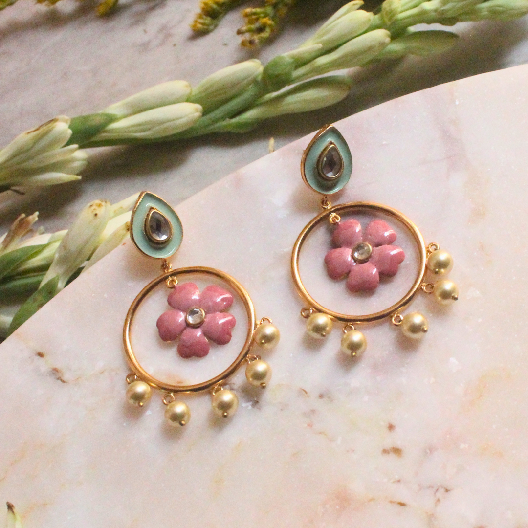 Pair of Gulbahar Enamel Meena Earrings featuring hand-painted pink enamel flowers inside golden hoops, adorned with faux pearl drops and pastel teardrop studs with kundan-style accents