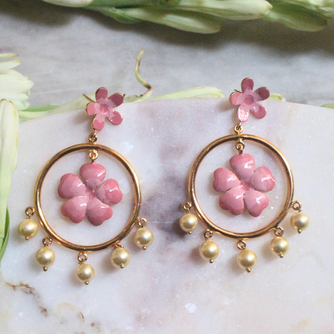 Pair of Gulnoor Enamel Pearl Bloom Earrings with pink enamel flowers in golden hoops, accented by floral stud tops and faux pearl drops