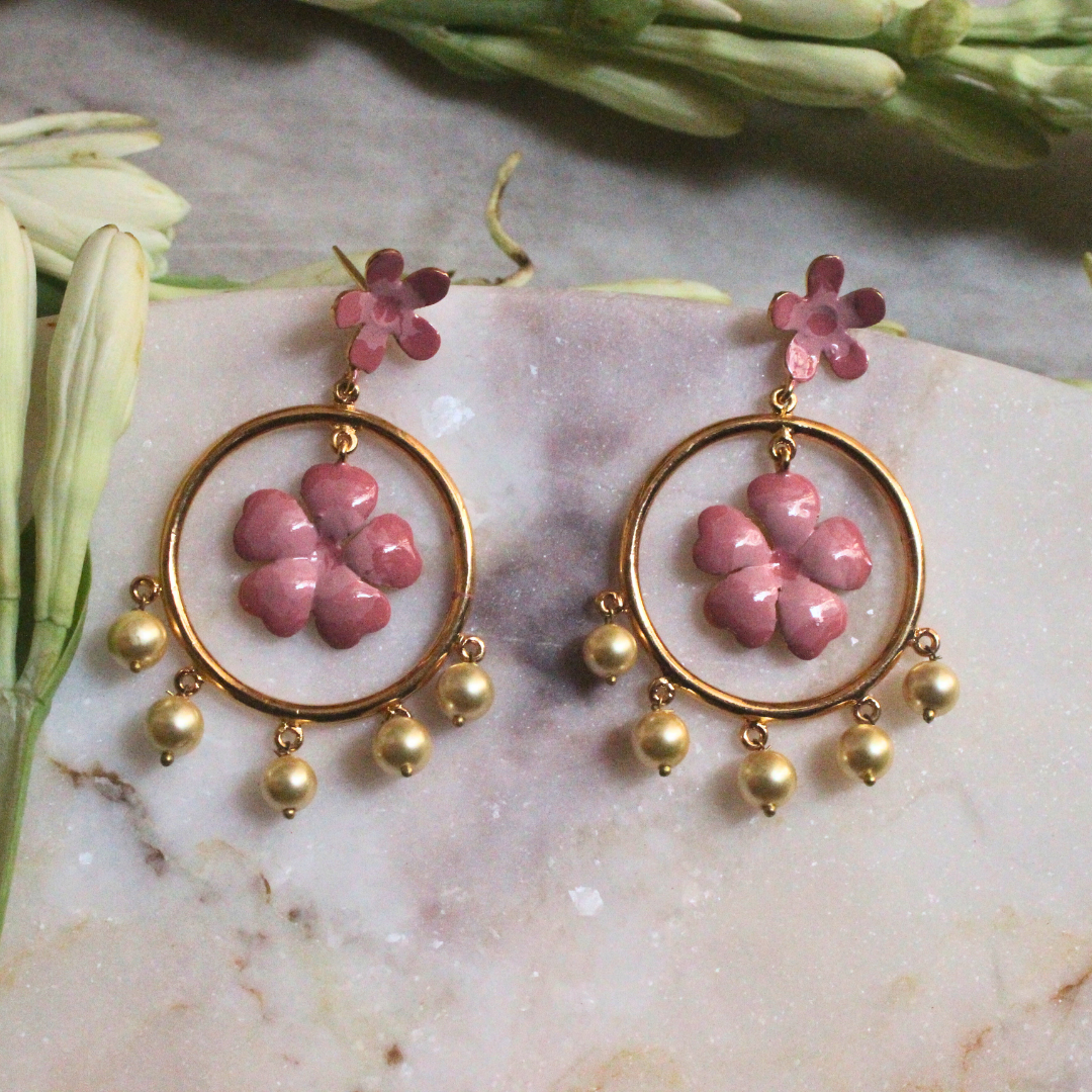 Pair of Gulnoor Enamel Pearl Bloom Earrings with pink enamel flowers in golden hoops, accented by floral stud tops and faux pearl drops