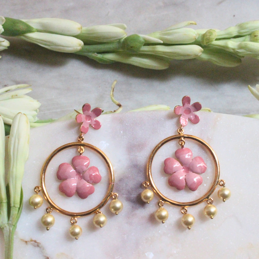 Pair of Gulnoor Enamel Pearl Bloom Earrings with pink enamel flowers in golden hoops, accented by floral stud tops and faux pearl drops