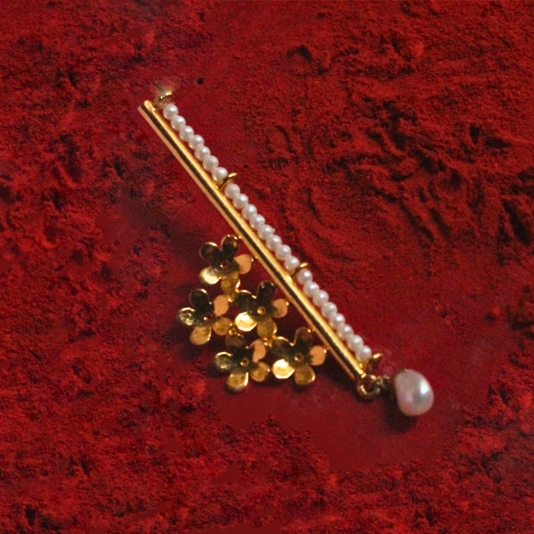 Handcrafted brass earrings with 18K rhodium gold plating, featuring golden floral clusters, a vertical row of faux pearl beads, and a single drop pearl