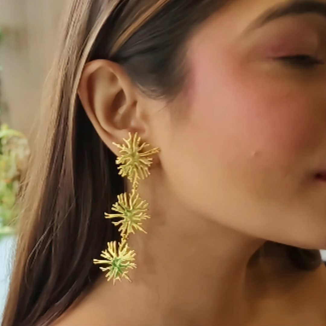 Brass gold-plated Trio Blossom Earrings featuring three cascading floral designs