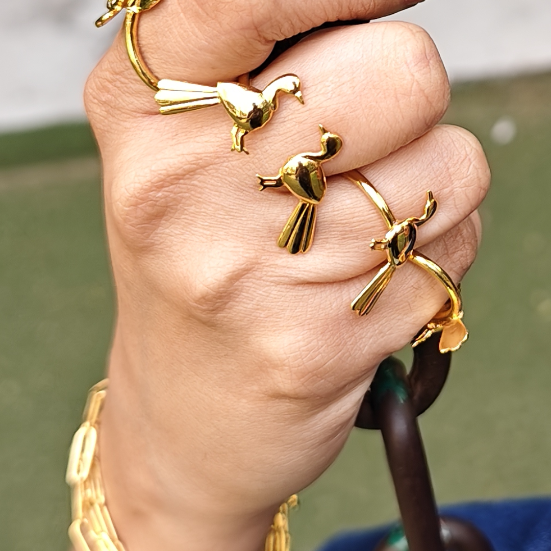 Brass gold-plated open ring featuring a single sculpted bird in flight