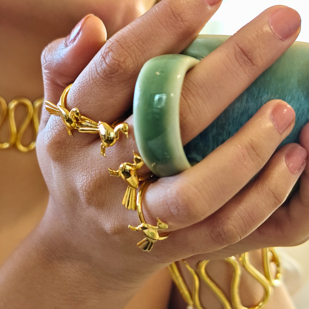 Brass gold-plated open ring featuring a single sculpted bird in flight