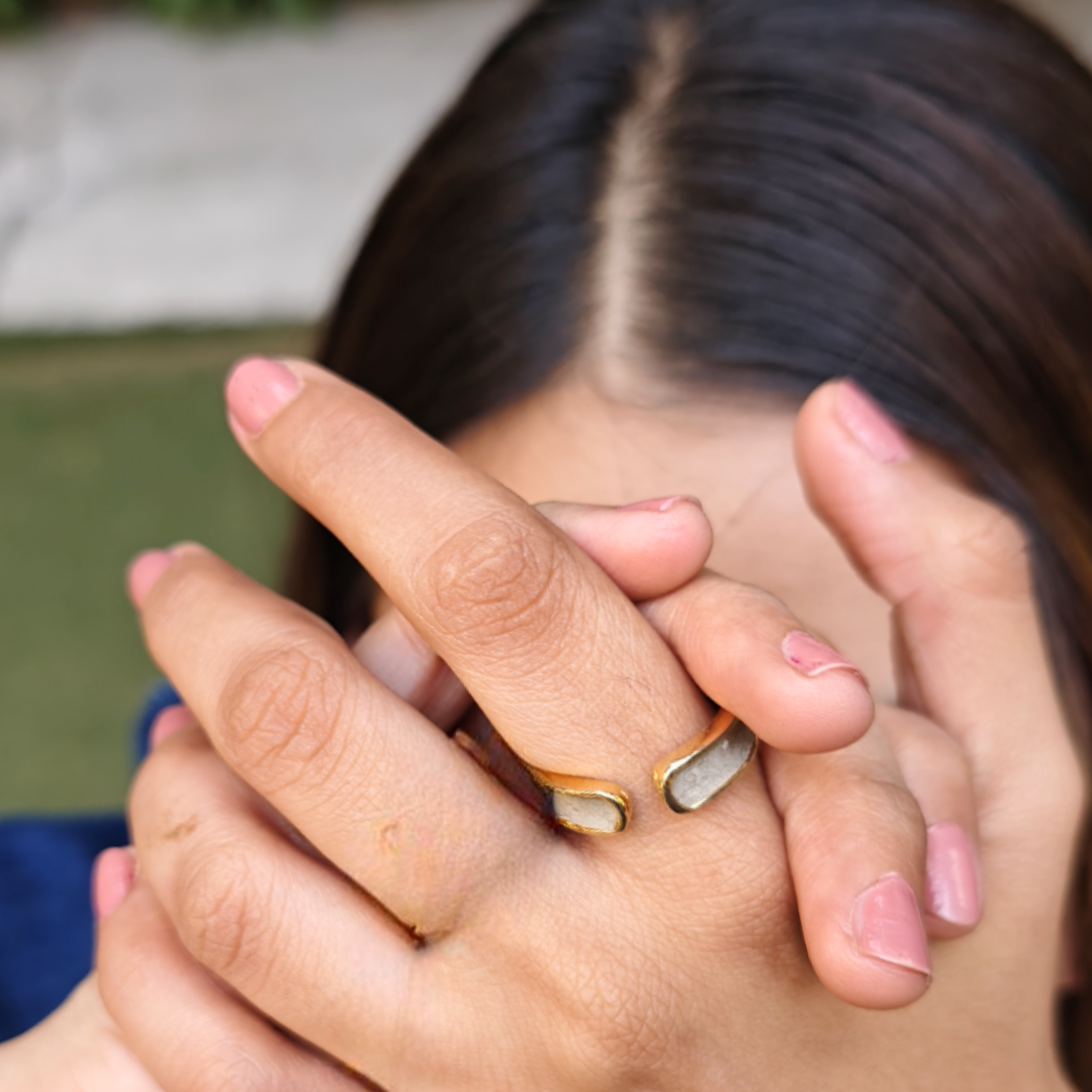 Open-ended brass and gold-plated ring featuring a rectangular cement slab and crescent moon detail