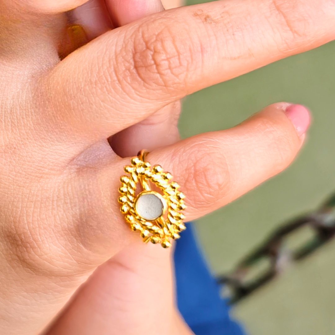 Gold-plated Cement Ember Ring with a smooth cement center and intricate beaded halo design