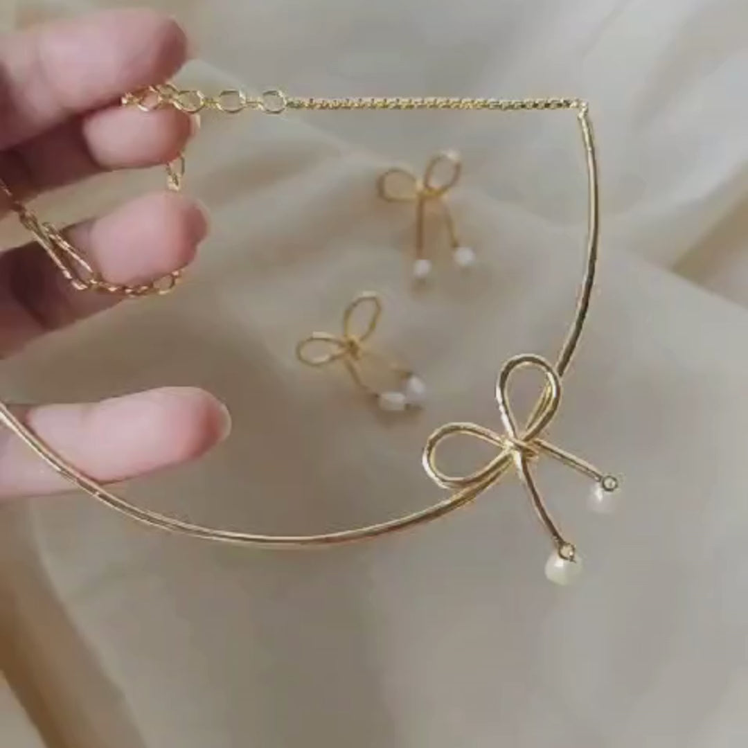 18K rhodium gold-plated brass bow necklace with baroque pearl drops