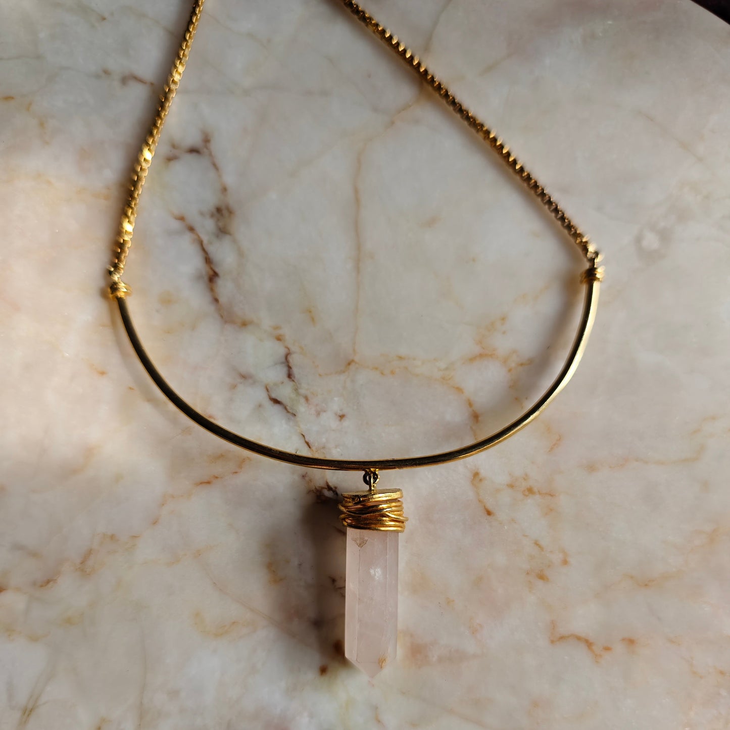 Necklace with a pendant on a marble surface