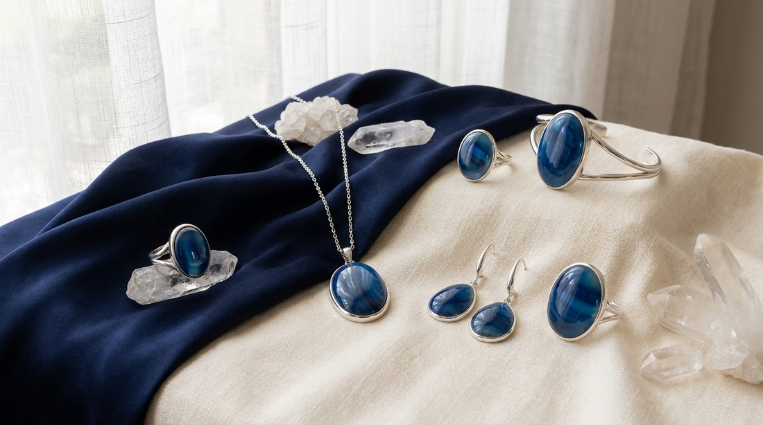 Blue onyx gemstone jewelry displayed in a luxury editorial setting with rings and pendants