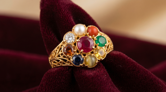 Navratna ring with nine gemstones including ruby, emerald and sapphire set in gold on velvet – KANSYA Jewellery