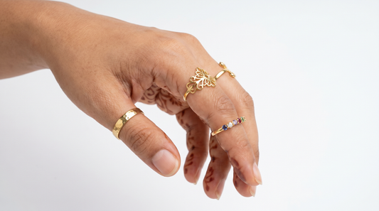 Adjustable gold rings with plain, floral and stone-set designs on woman's hand – KANSYA Jewellery