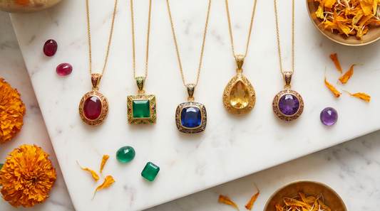 Colourful gemstone pendants in ruby red, emerald green, sapphire blue and amethyst purple on white marble – KANSYA Jewellery