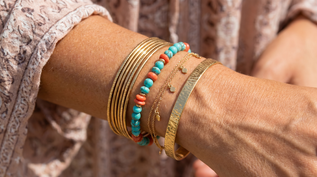 Woman's wrist with layered gold bangles, beaded bracelet and chain bracelet stacked – KANSYA Jewellery