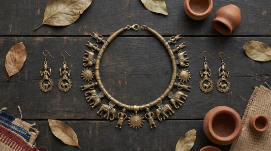 Dhokra tribal brass jewellery with lost-wax cast necklace and earrings on dark wood – KANSYA Jewellery