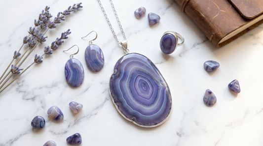 Banded agate slice pendant in purple blue and white with concentric ring patterns on white marble – KANSYA Jewellery