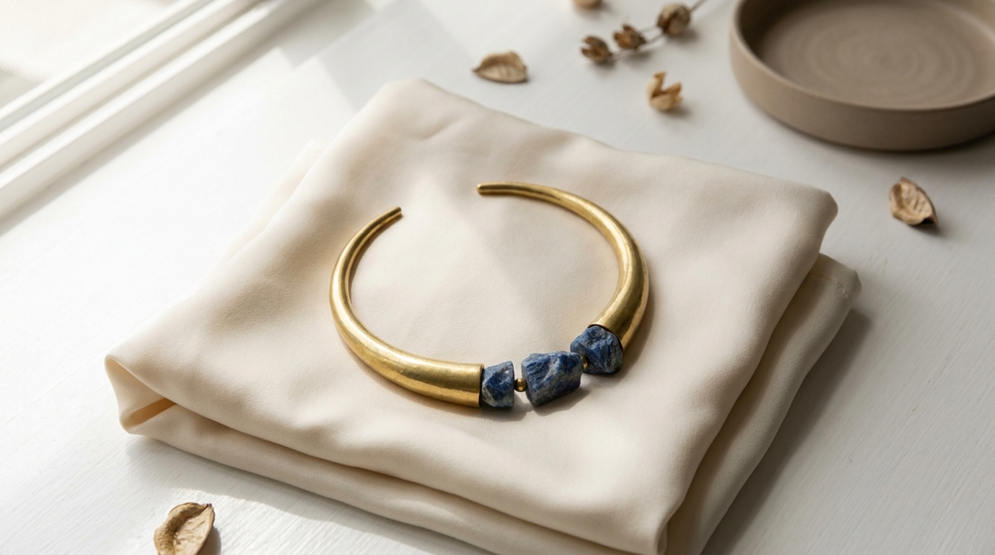 brass jewellery guide India - warm golden pieces on terracotta fabric