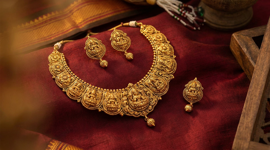 Kolhapuri jewellery Maharashtra - gold temple necklace and earrings on maroon fabric