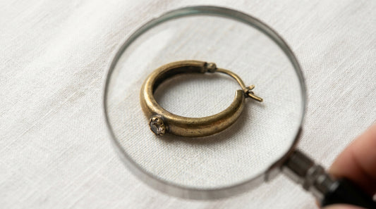how to identify fake jewellery India - magnifying glass examining brass earring