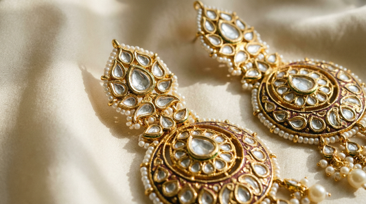 how to care for kundan jewellery - kundan earrings on cream silk