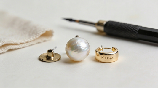 Gold earring components and a pearl