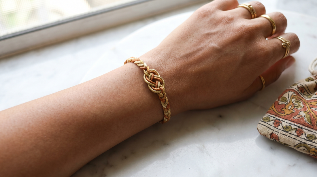 Handcrafted gold and silk thread knot bracelet on a woman's wrist – KANSYA Jewellery