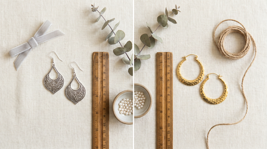 Rhodium plated silver earrings beside gold plated brass earrings on cream linen – KANSYA Jewellery