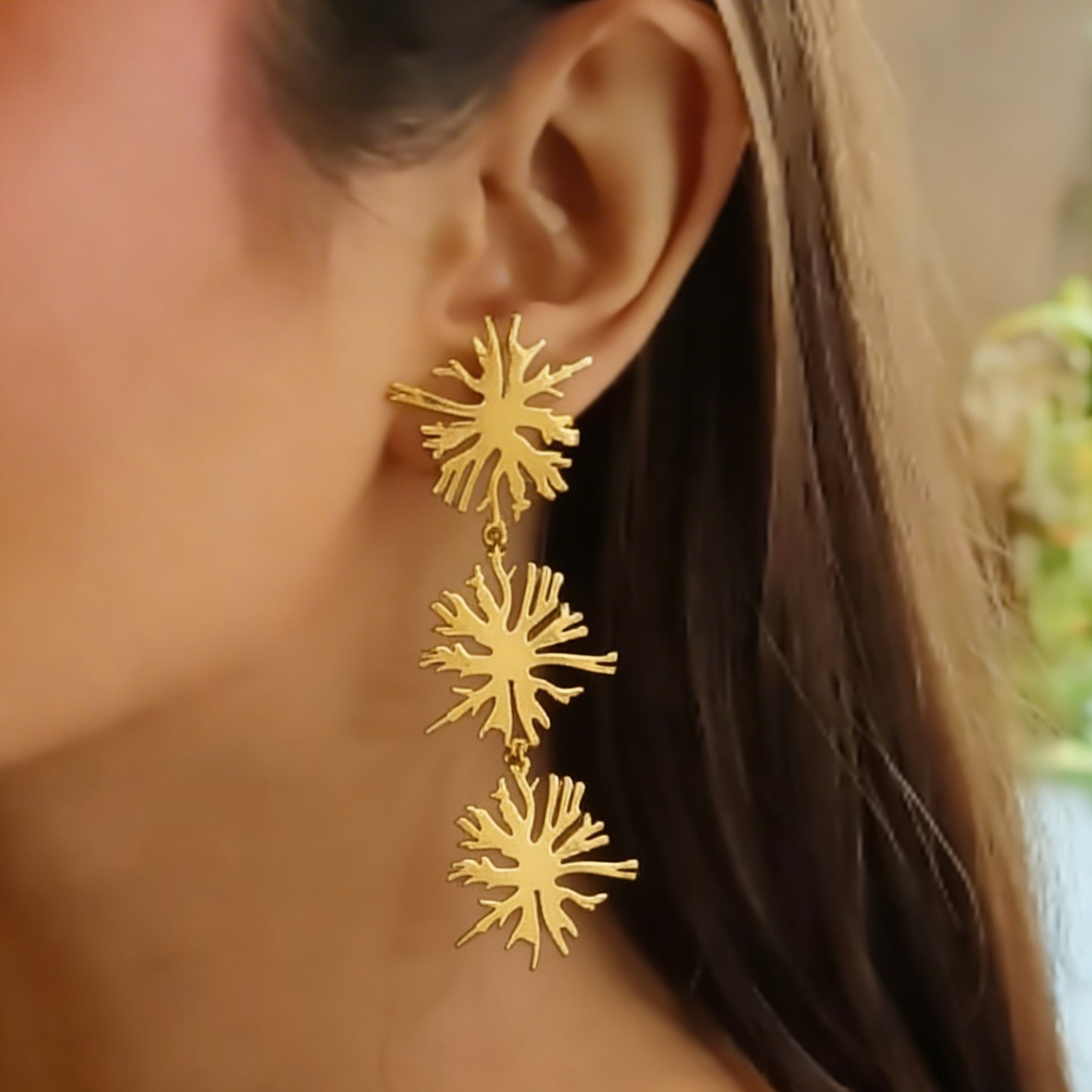 a model wearing the trio blossom earrings