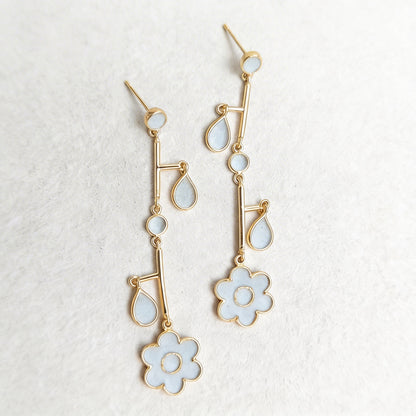 Gold and cement filled earrings on a textured white background