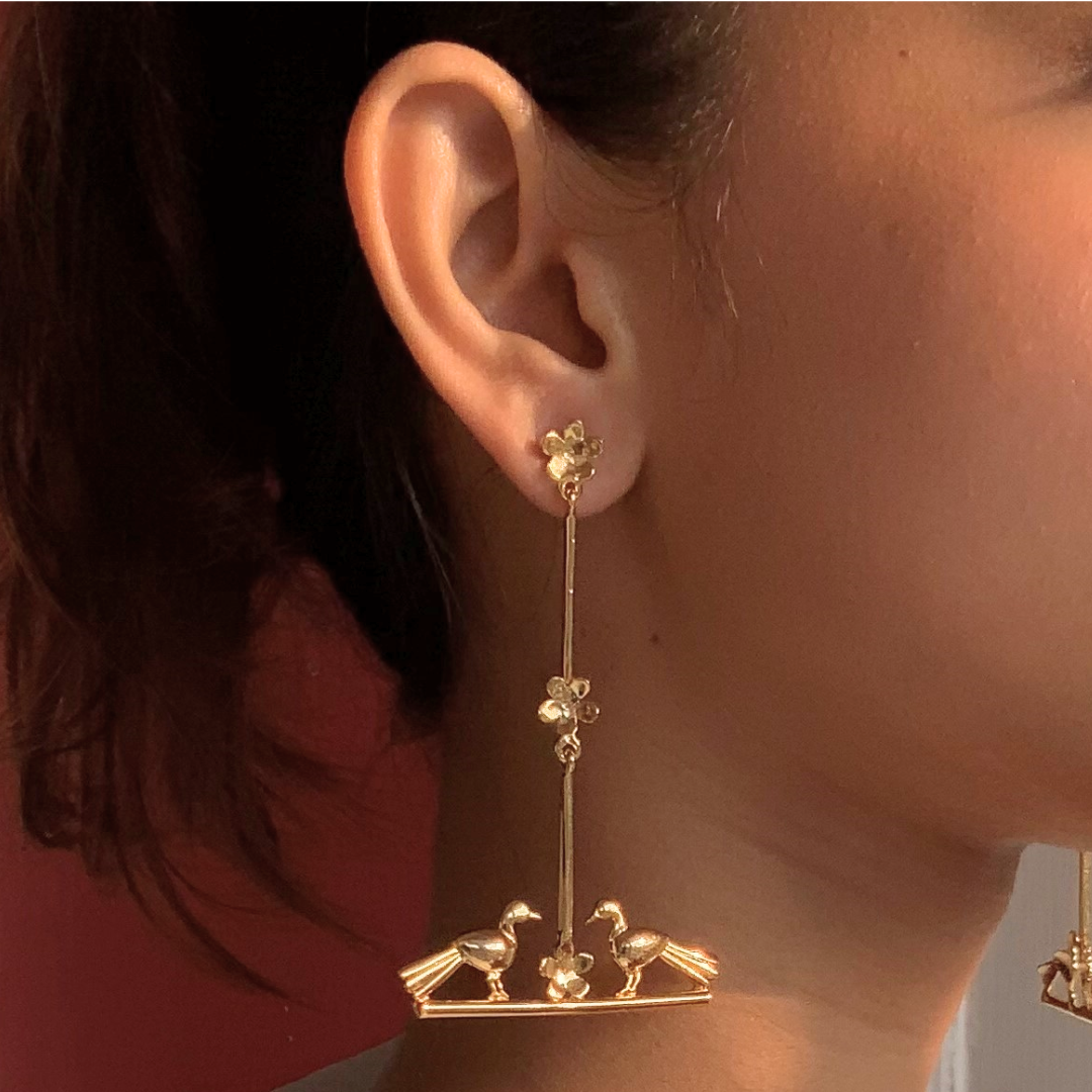 Nature-inspired Love Birds earrings with golden birds and flower accents, made of brass and rhodium gold