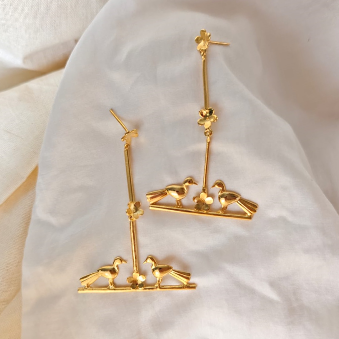 Nature-inspired Love Birds earrings with golden birds and flower accents, made of brass and rhodium gold