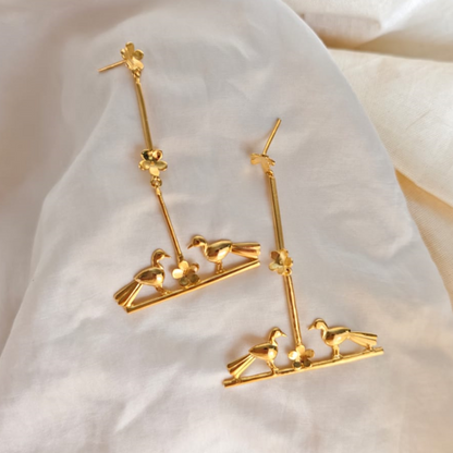 Nature-inspired Love Birds earrings with golden birds and flower accents, made of brass and rhodium gold
