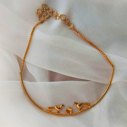 Love Birds necklace with sculptural birds and floral centerpiece, made from brass and 18K rhodium gold