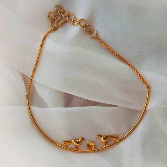 Love Birds necklace with sculptural birds and floral centerpiece, made from brass and 18K rhodium gold