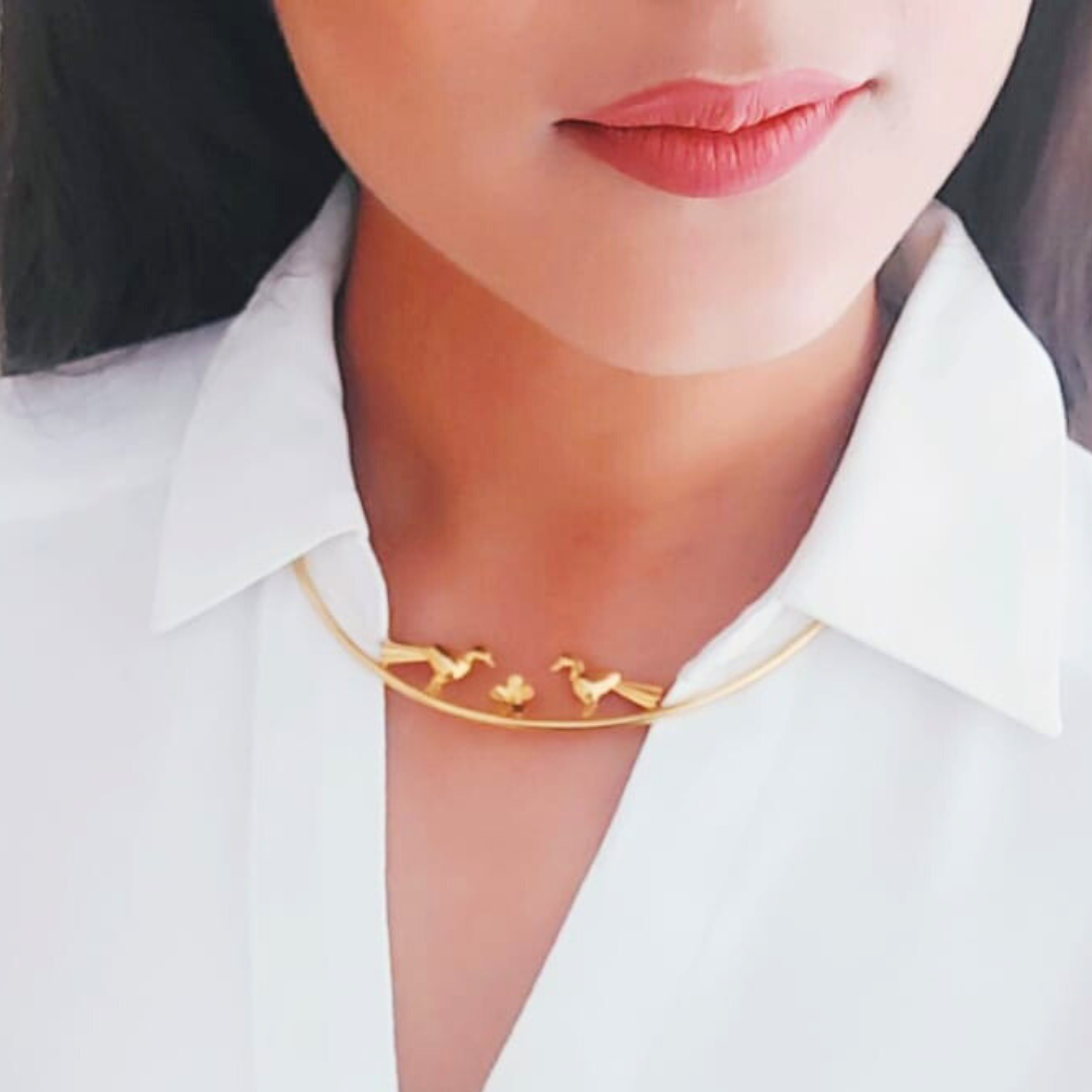 Love Birds necklace with sculptural birds and floral centerpiece, made from brass and 18K rhodium gold