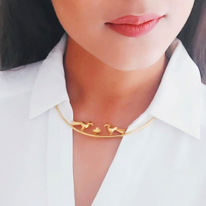 Love Birds necklace with sculptural birds and floral centerpiece, made from brass and 18K rhodium gold